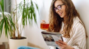 Pretty,Woman,At,Home,Drinking,Tea,And,Reading,Book,Or
