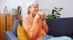 Portrait,Of,Mature,Adult,Woman,Smelling,Aroma,Coffee,Wrapped,In