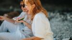 Two,Friends,Laughing,And,Enjoying,Watermelon,During,A,Sunny,Picnic