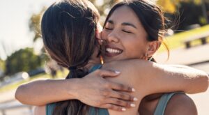 Shot,Of,Two,Sporty,Friends,Celebrating,With,A,Hug,After