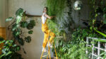 Joyful,Young,Woman,Gardener,In,Orange,Overalls,Standing,On,A