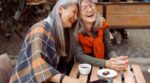 Pretty,Senior,Asian,Woman,Puts,Head,On,Laughing,Friend,Shoulder