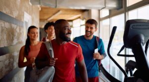 Happy,Athletic,Friends,Going,To,Exercise,Class,In,Health,Club.